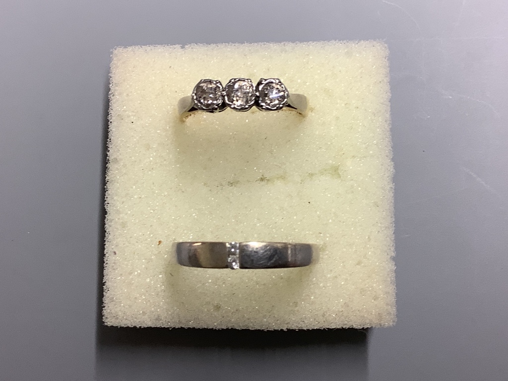 An 18ct and plat, three stone diamond ring, size L gross 2.6 grams and a 9ct white metal and diamond ring, gross 2.1 grams.